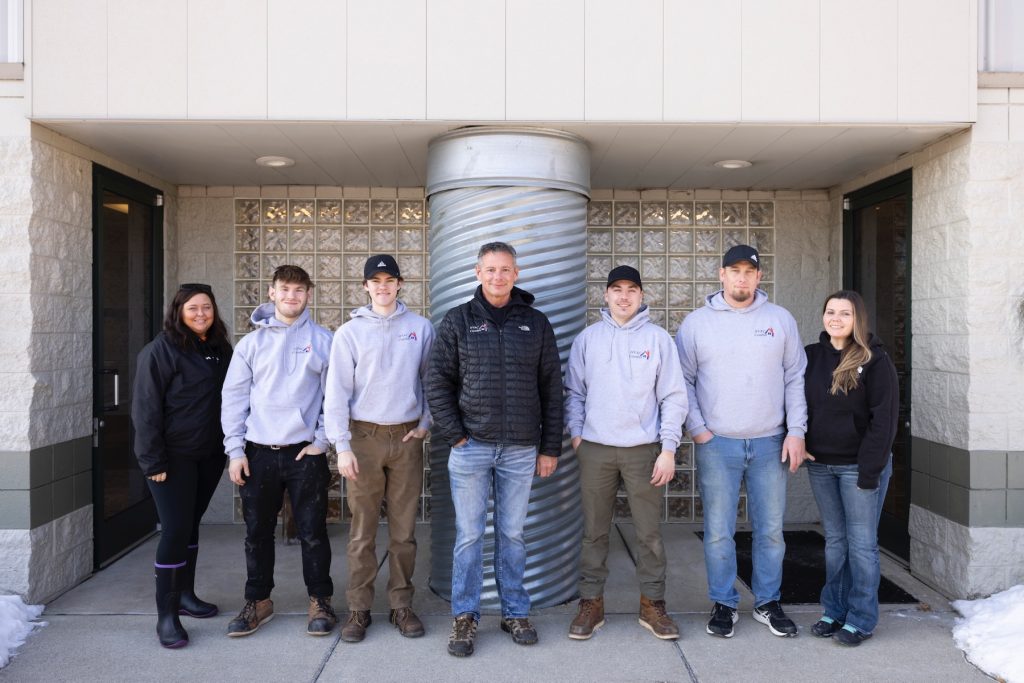 team standing outside building hvac comfort