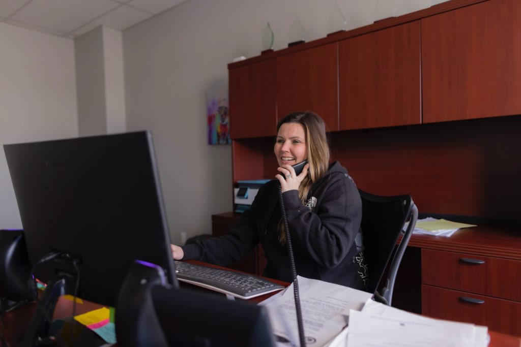 young woman on phone with customer hvac comfort