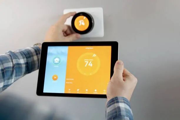 Smart thermostat setup using a tablet.