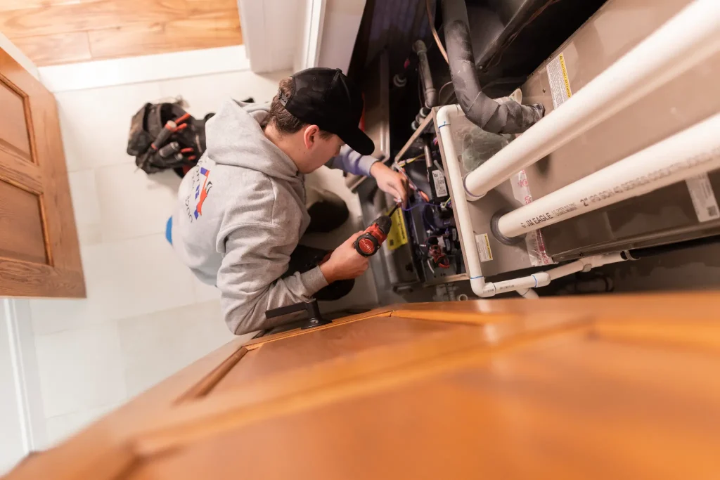 HVAC comfort tech repairing an AC unit