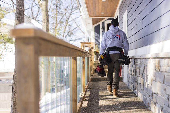 tech walking to front door hvac comfort