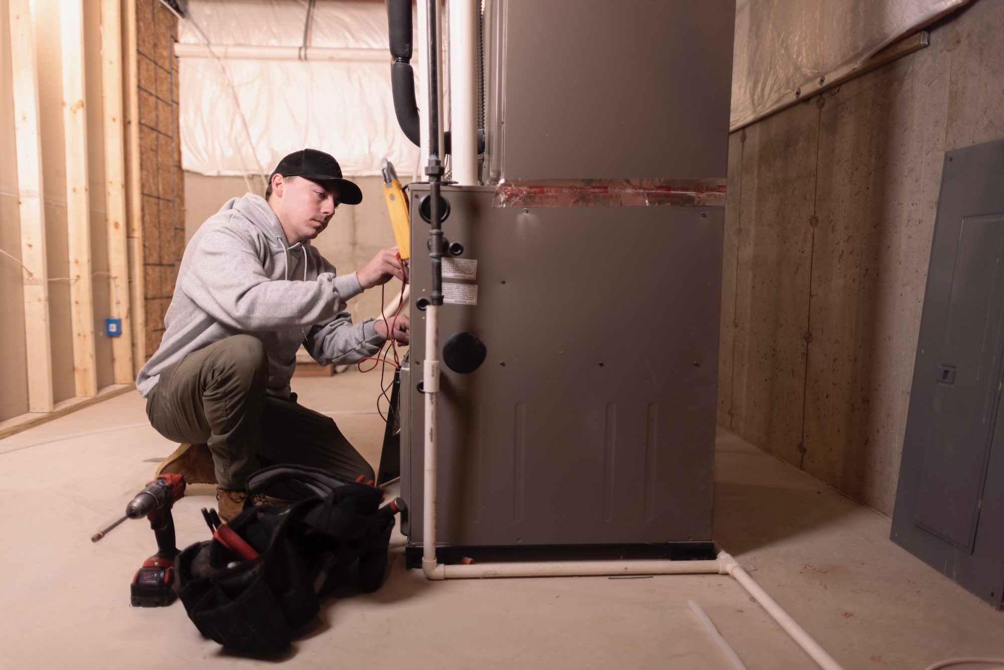 hvac comfort inc furnace repair tech working iin customers home house 2000x2000