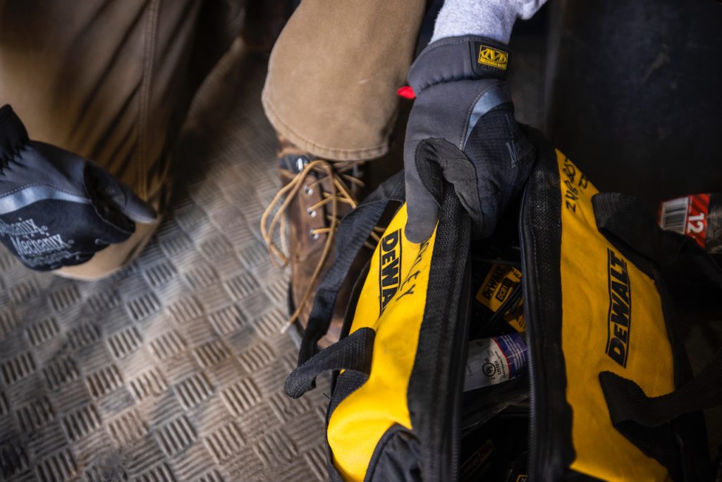 Person with hvac repair bag near them on the floor