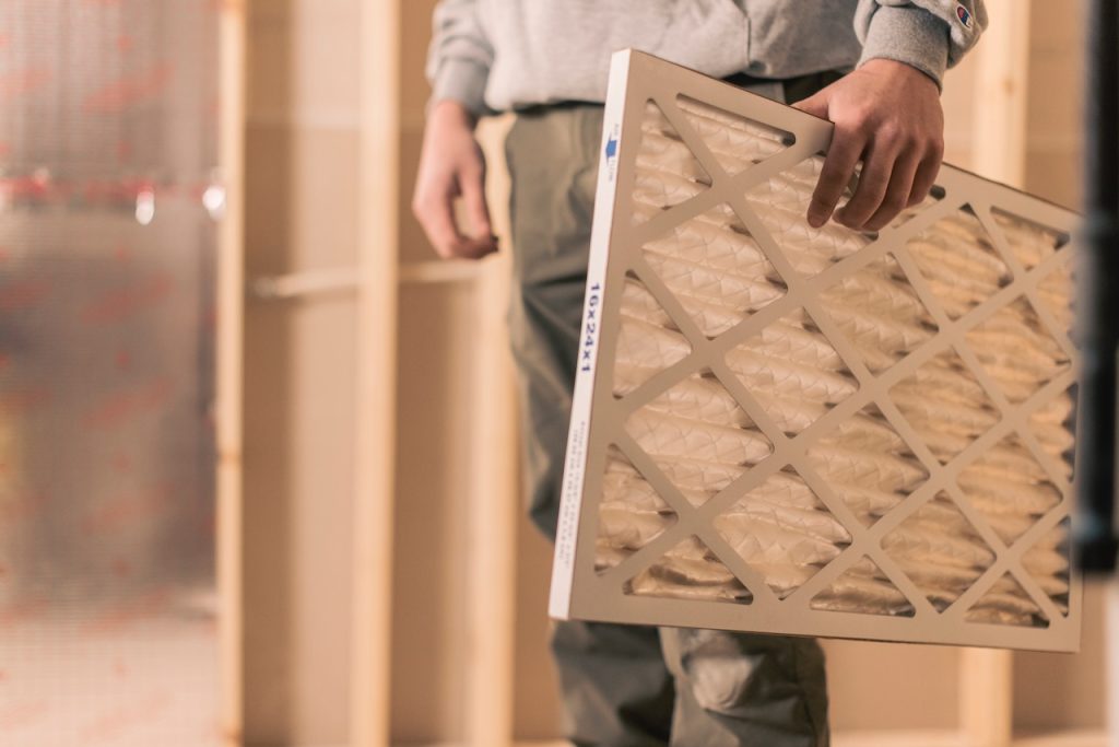 hvac comfort inc ac specialist replacing air filter for residental homeowner